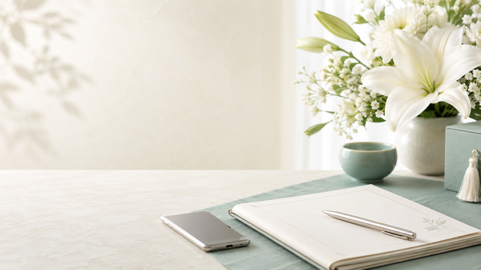 Flowers, a notebook, and a smartphone representing the contact form